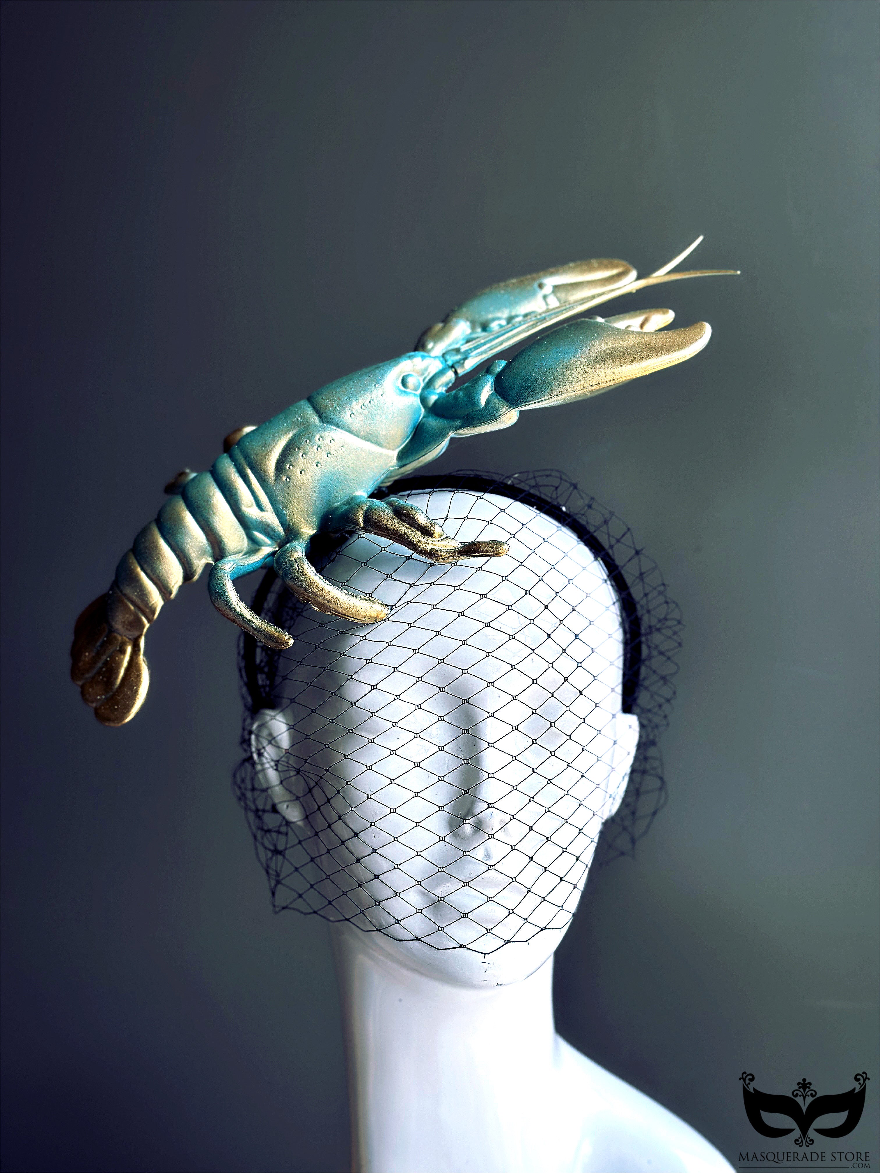 Turquoise and gold lobster fascinator hat with netted veil, perfect for Derby, masquerade balls, couture shows, and avant-garde fashion.