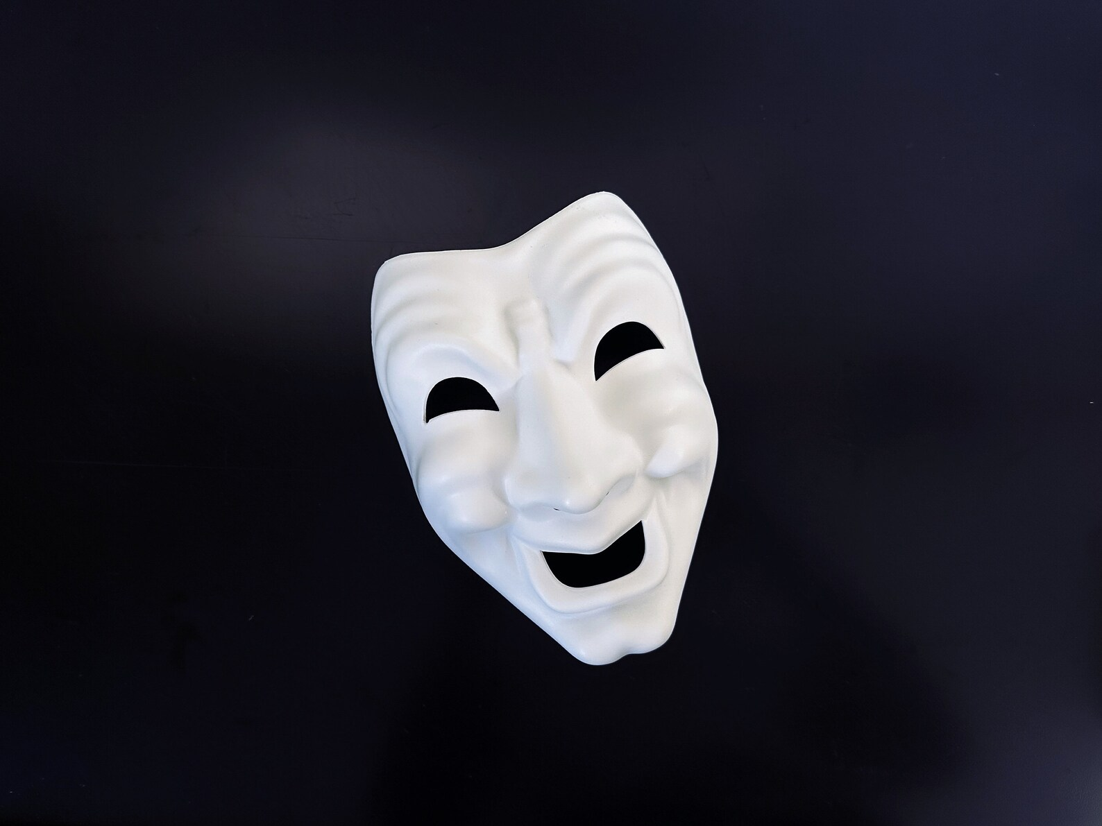 White comedy theater masquerade mask with a smiling expression for costumes, cosplay, Halloween, and stage productions.