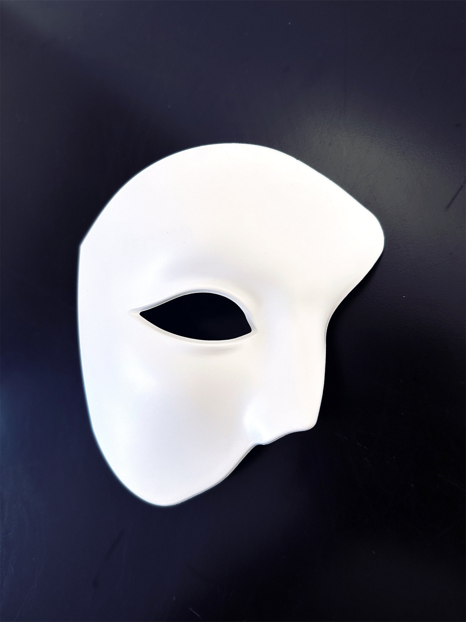 White phantom half face masquerade mask with Venetian opera design, ideal for Halloween, Carnival, cosplay, and masquerade balls.