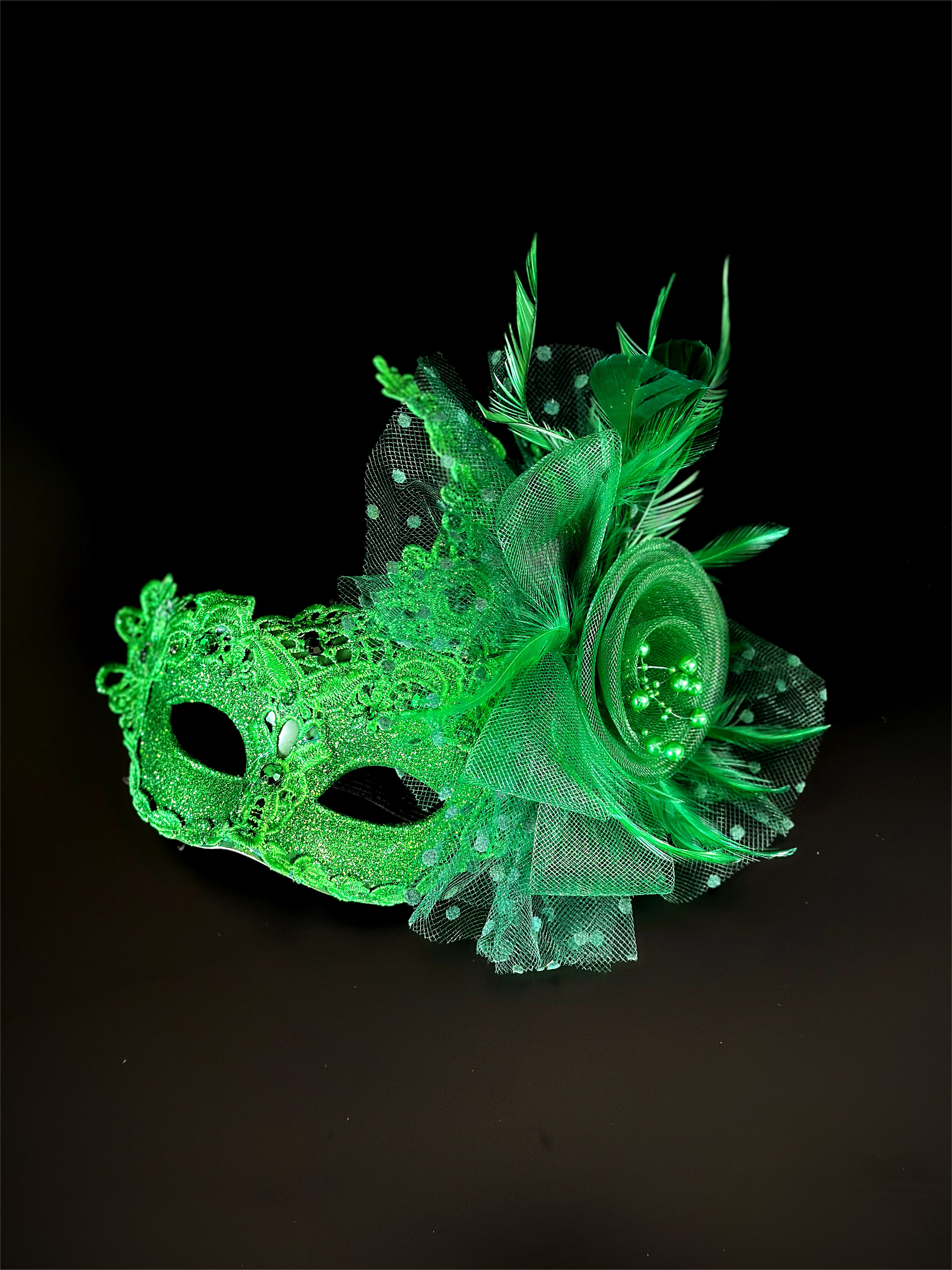 Green lace masquerade mask for women with glitter, feathers, and mesh rosette floral detail.