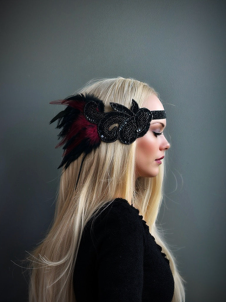 Black beaded flapper headband with rich red feathers, perfect for Gatsby-themed parties and elegant occasions.