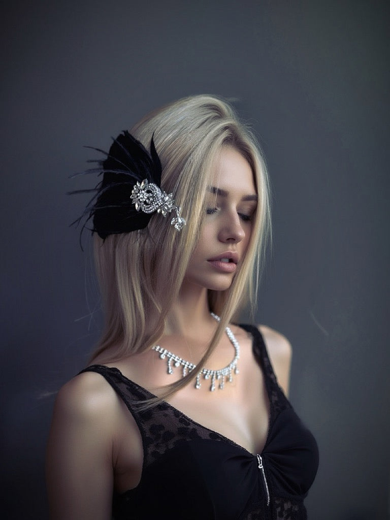 Black feather hair clip with sparkling rhinestone centerpiece, perfect for formal occasions and masquerade events.