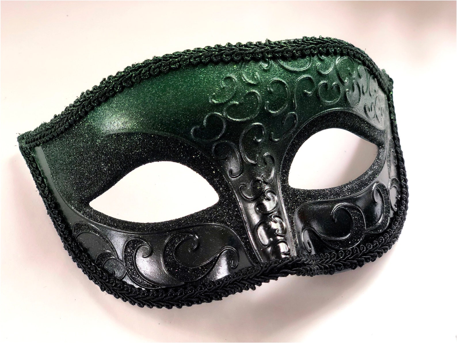 Black and emerald green couples masquerade masks with lace and rhinestone details for Mardi Gras, weddings, or Venetian balls.