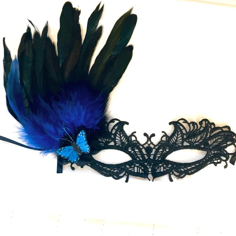 Elegant black lace masquerade mask with blue feathers and butterfly accent, ideal for prom, gala, or carnival.