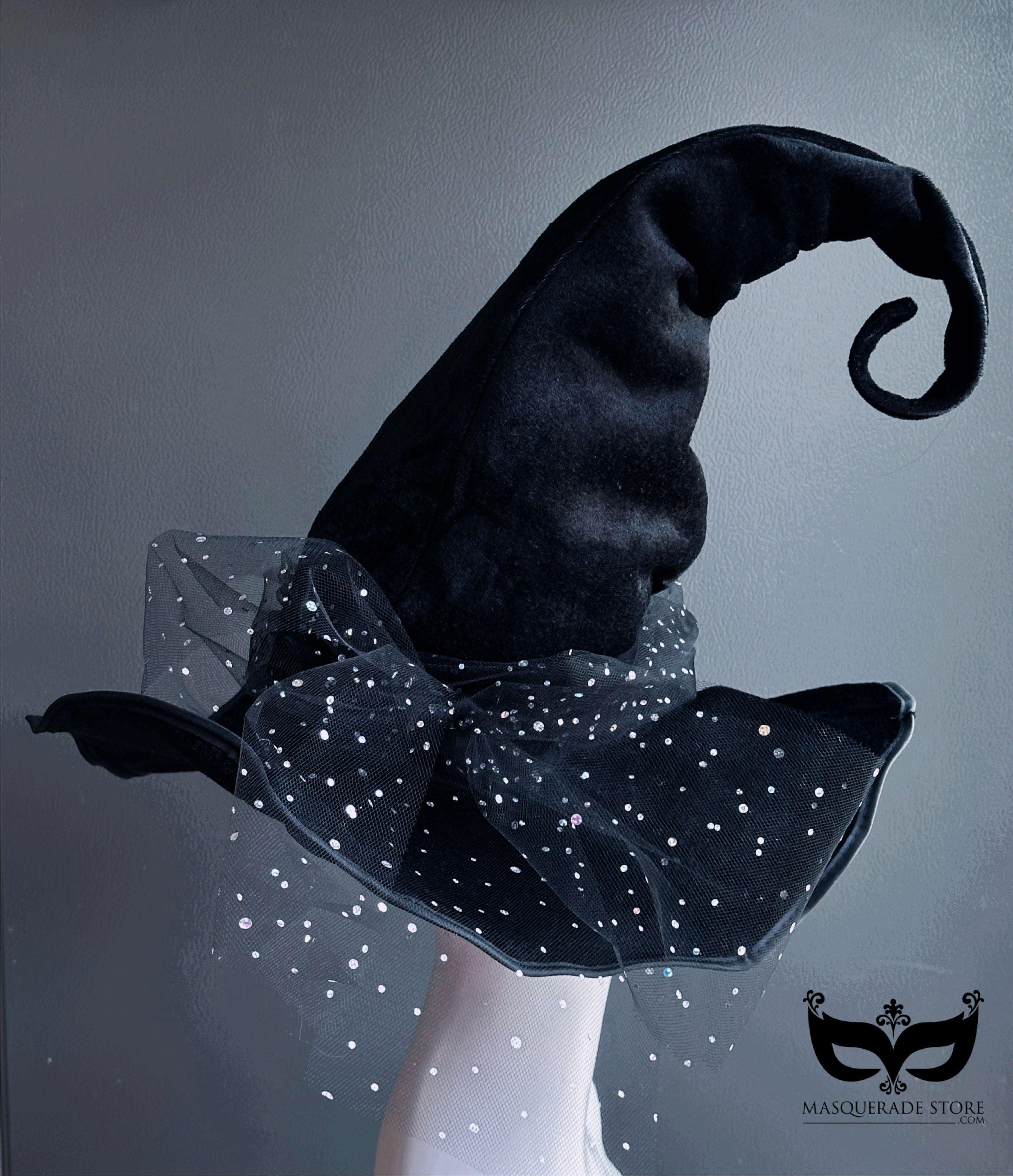 Curled black witch hat with sparkling starry tulle trim for Halloween costumes and witches balls.