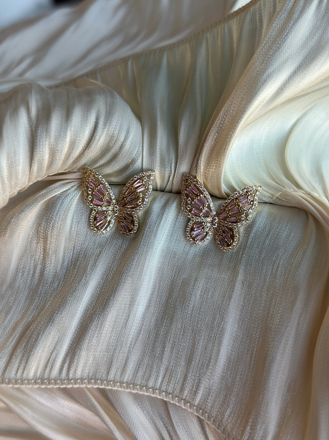Gold butterfly earrings with pink crystal wings