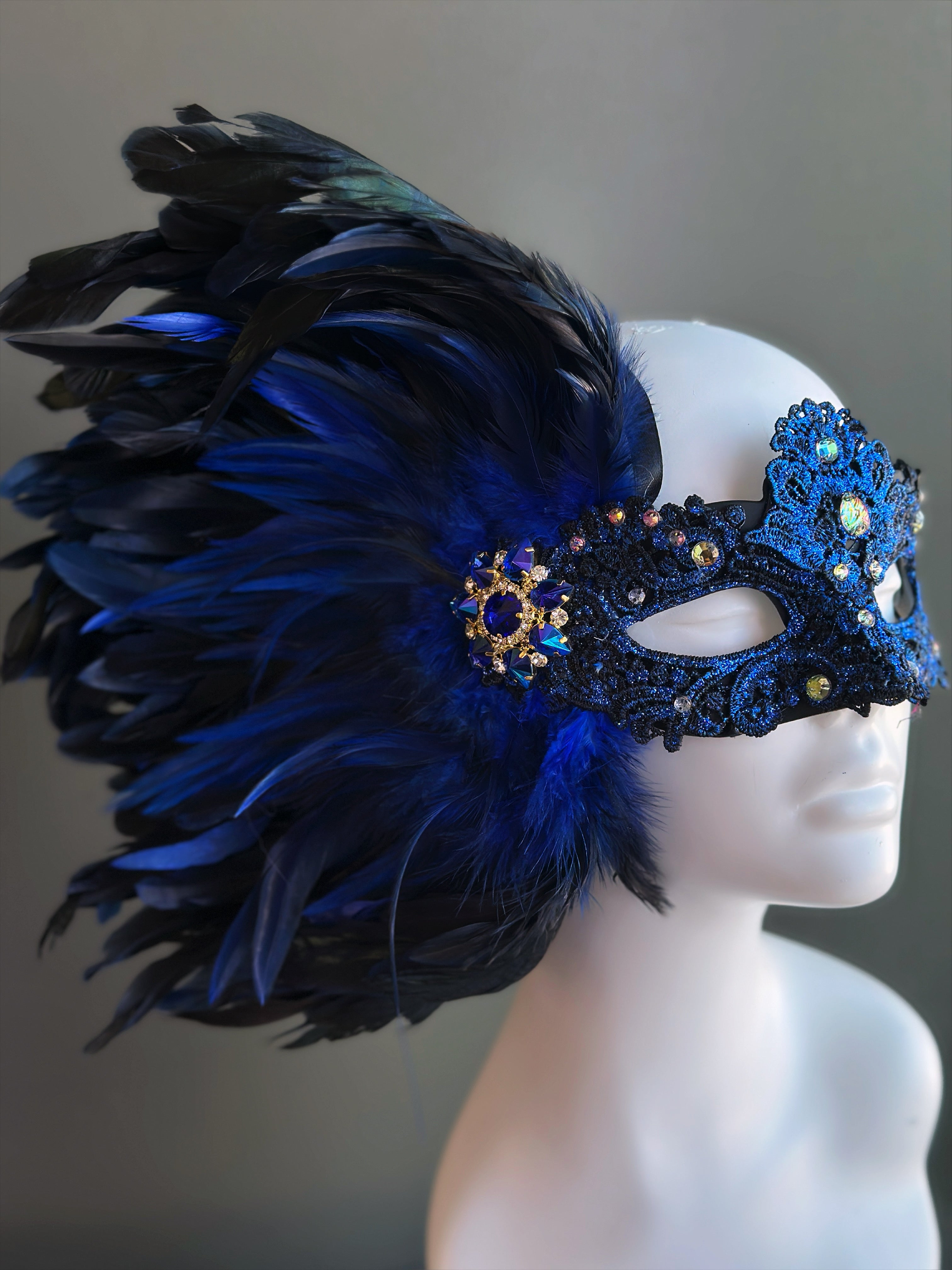 Royal blue and black feather masquerade mask for women with jeweled lace and brooch