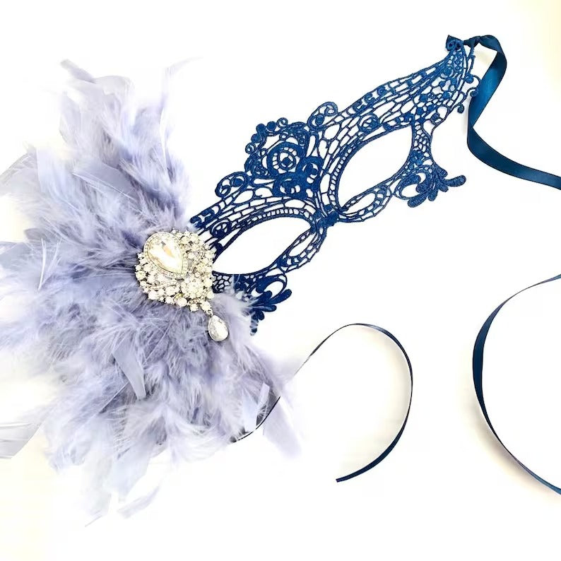 Elegant blue lace masquerade mask with feathers and pearl crystal brooch, perfect for Mardi Gras, prom, carnival, and Venetian balls.