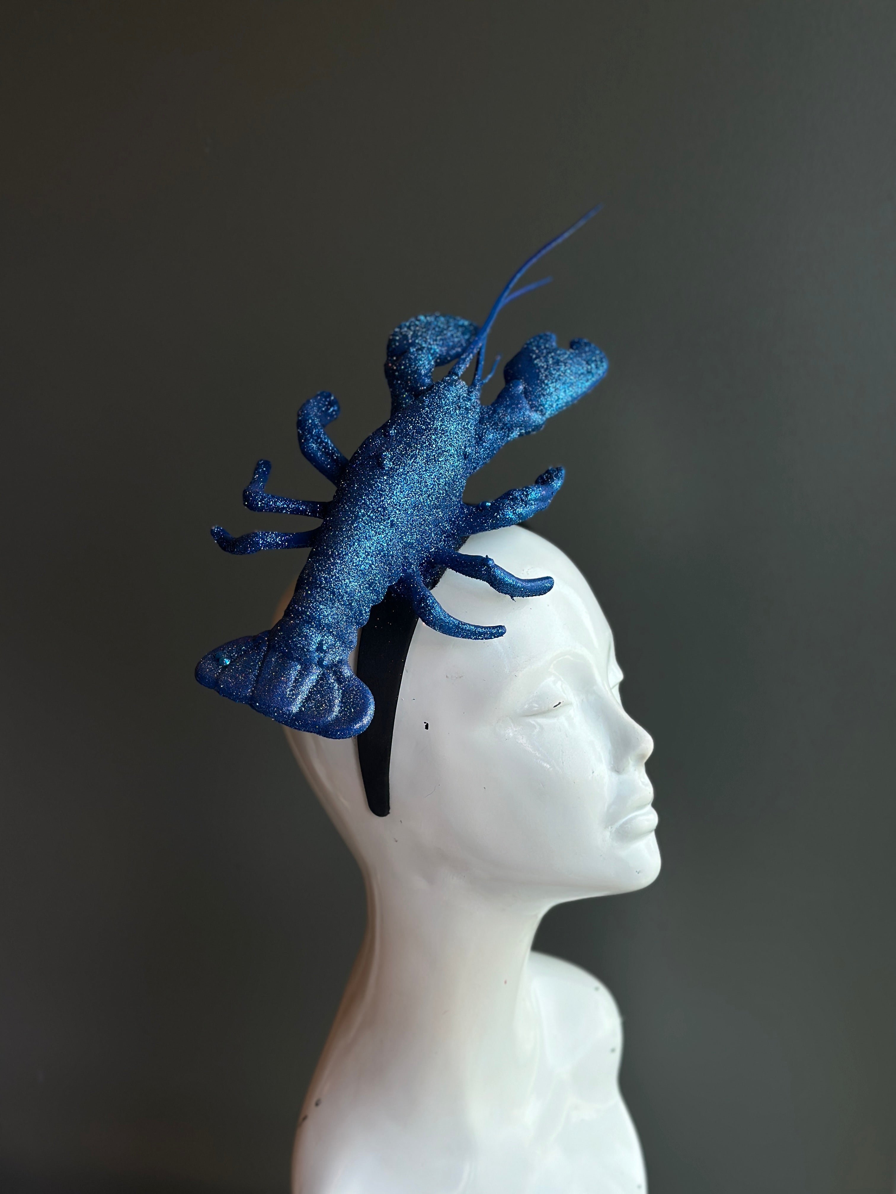 Blue lobster fascinator headpiece, a striking ocean-inspired accessory for seafood festivals and bold fashion statements.