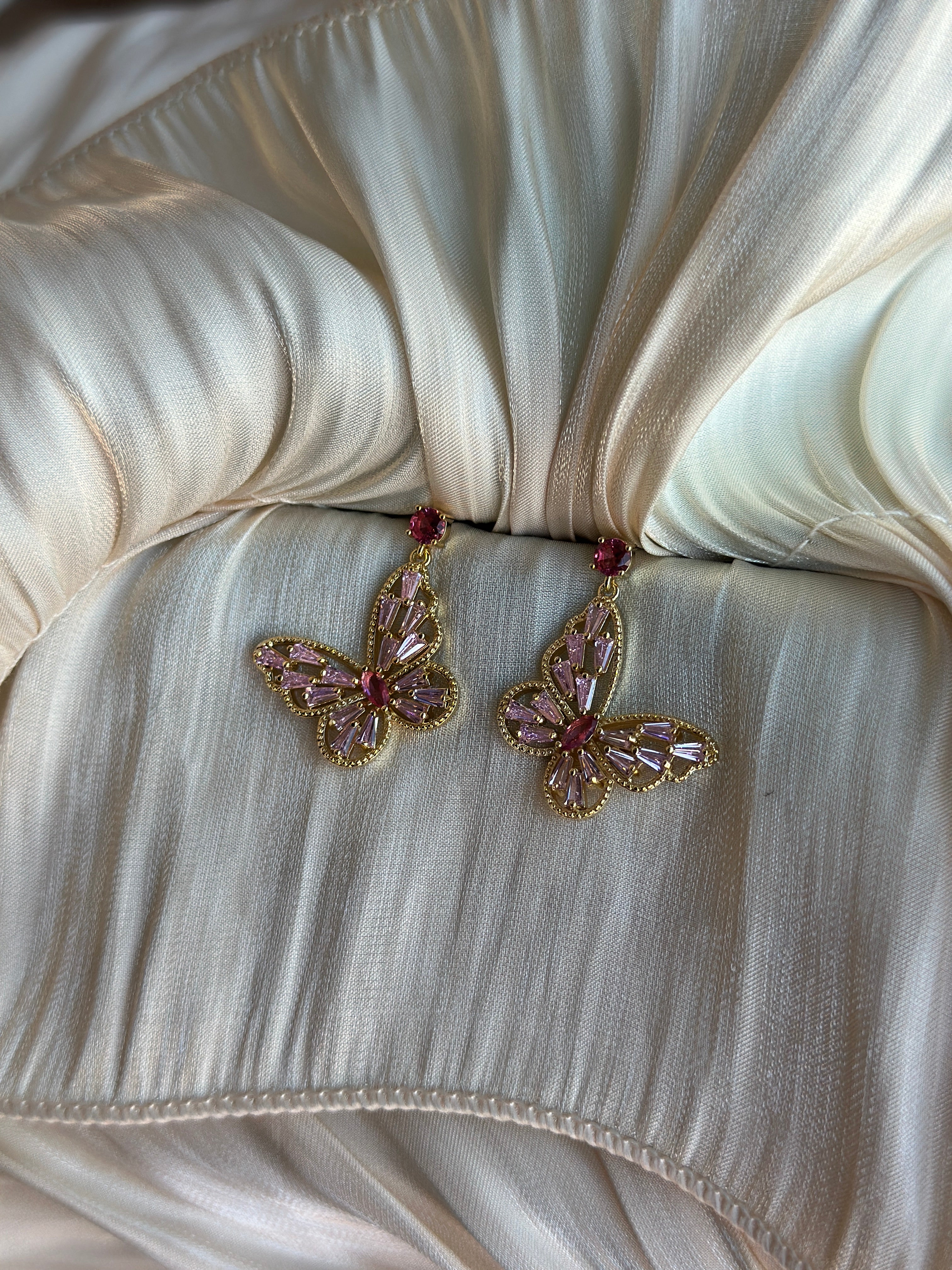 Dainty gold butterfly earrings with pink tops and pink crystal wings