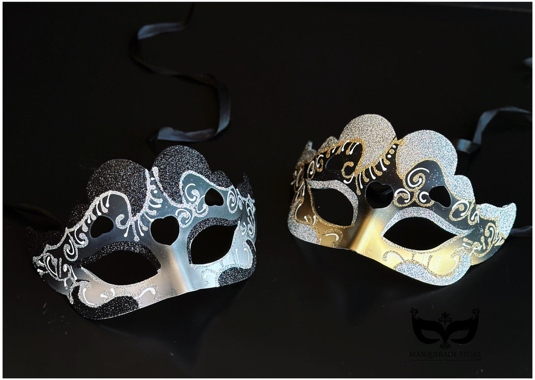 Bulk Venetian masquerade masks with heart-shaped accents, glitter finish, ornate scrollwork, and gold or silver metallic detailing.