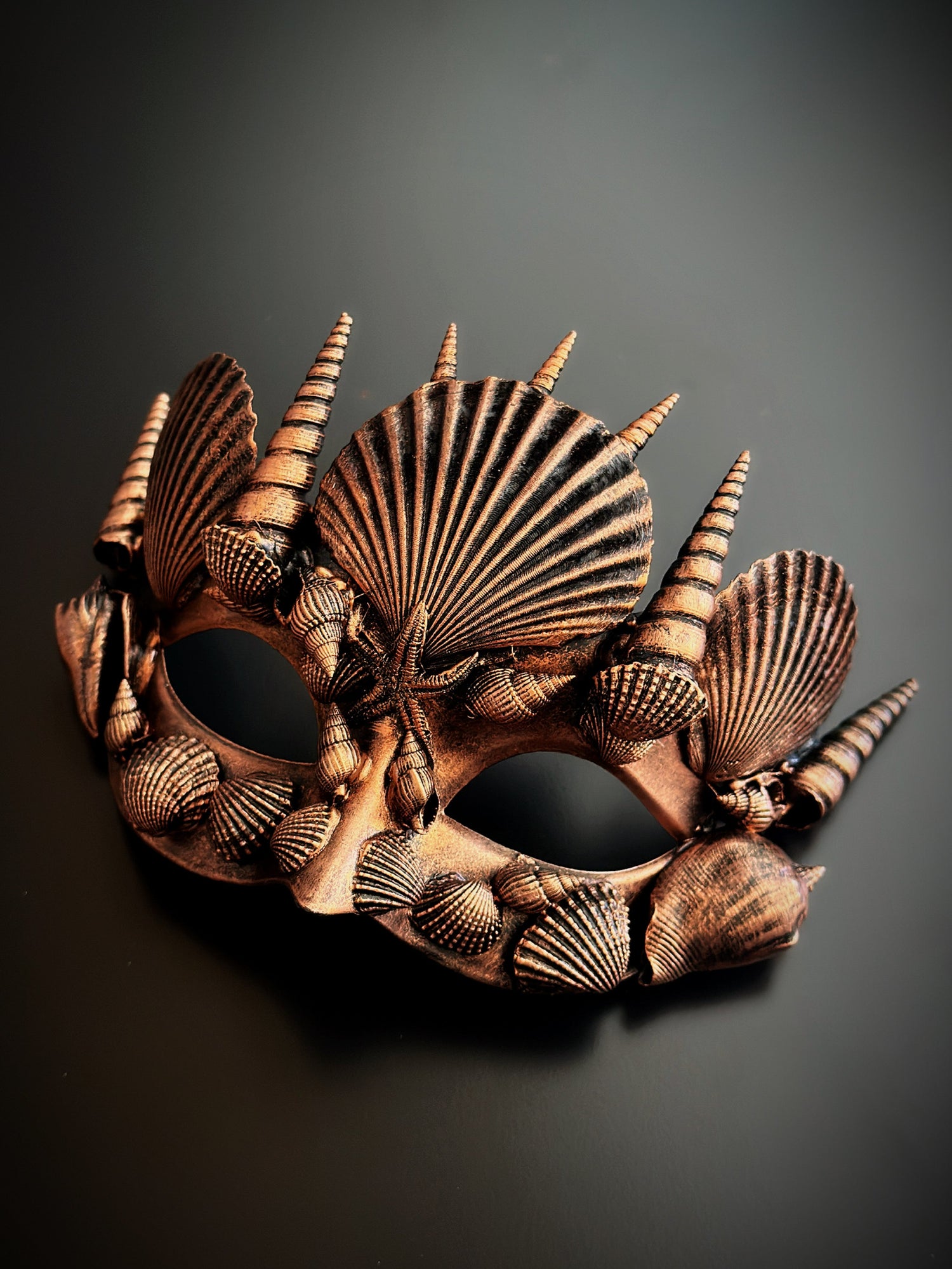 Copper mermaid masquerade mask with seashells and starfish in a metallic finish.