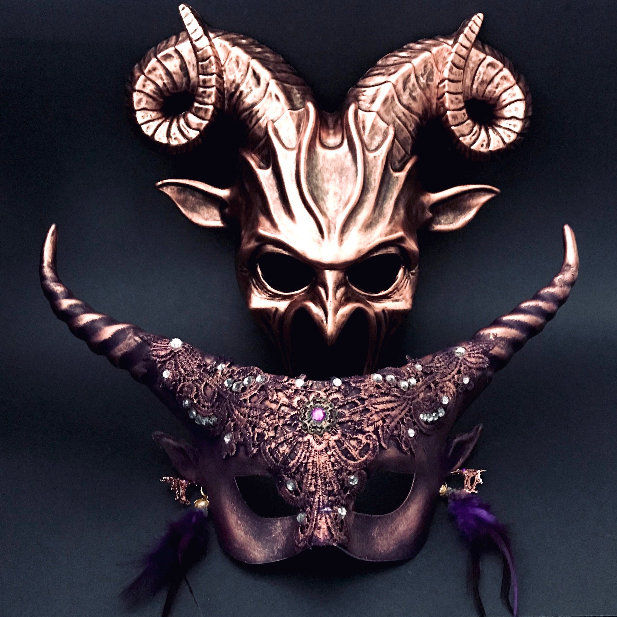 Copper and purple gothic couples masquerade masks with ram horns and lace.
