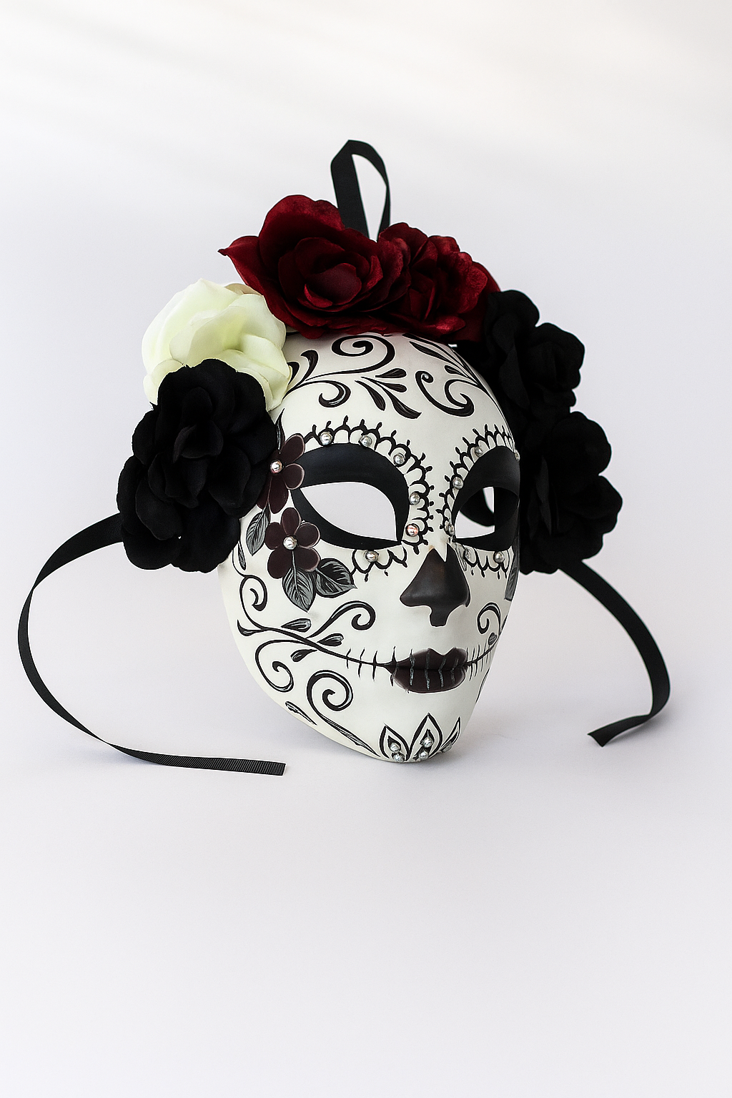White sugar skull mask with red and black floral crown.