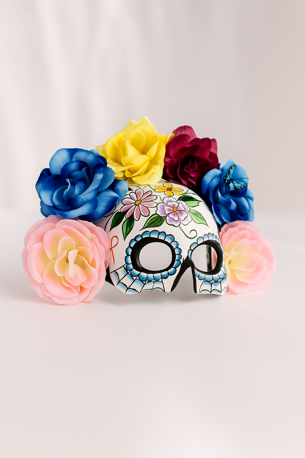 Colorful sugar skull mask with vibrant flower crown, Dia de los Muertos and Halloween skull costume mask with floral details.