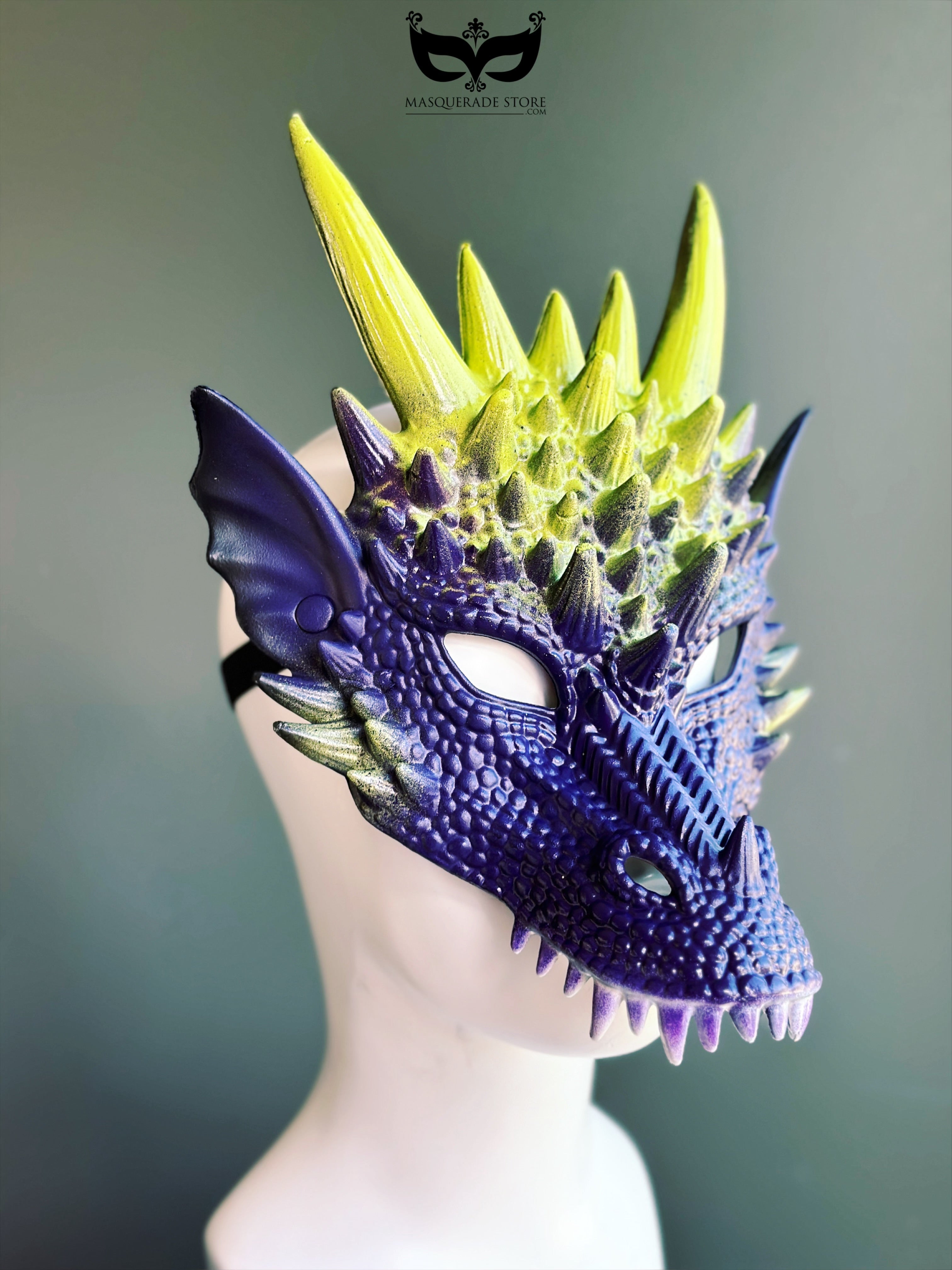 Purple yellow dragon masquerade mask with spiked horns and scales.