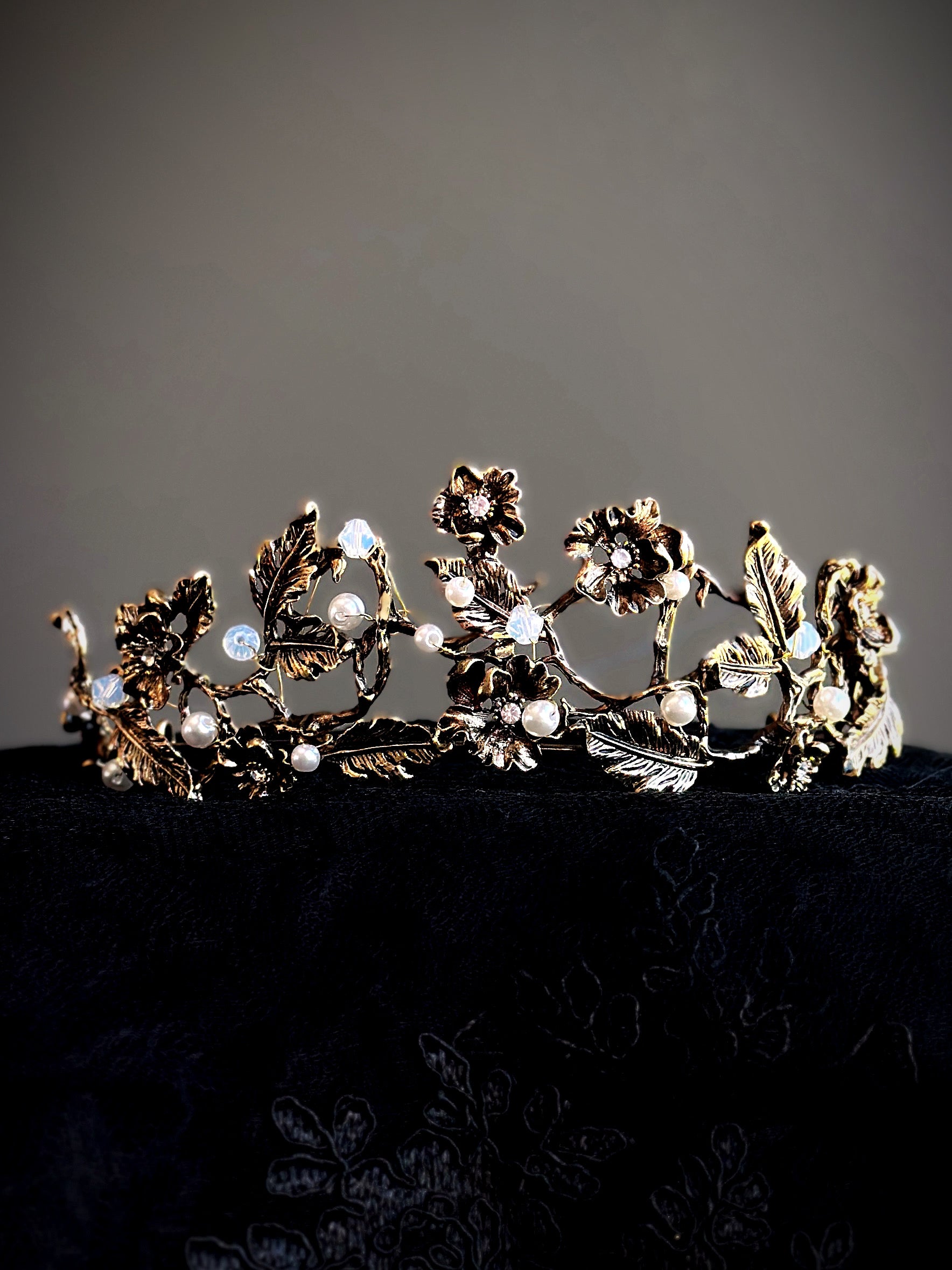 Gold floral crown with vine, pearl, and crystal detailing.