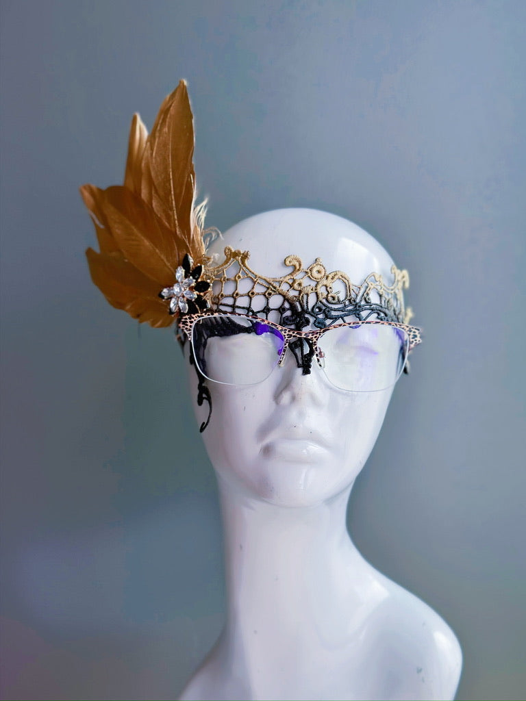 Gold black ombre mask with gold feathers, fastened with a clear crystal and black stone brooch