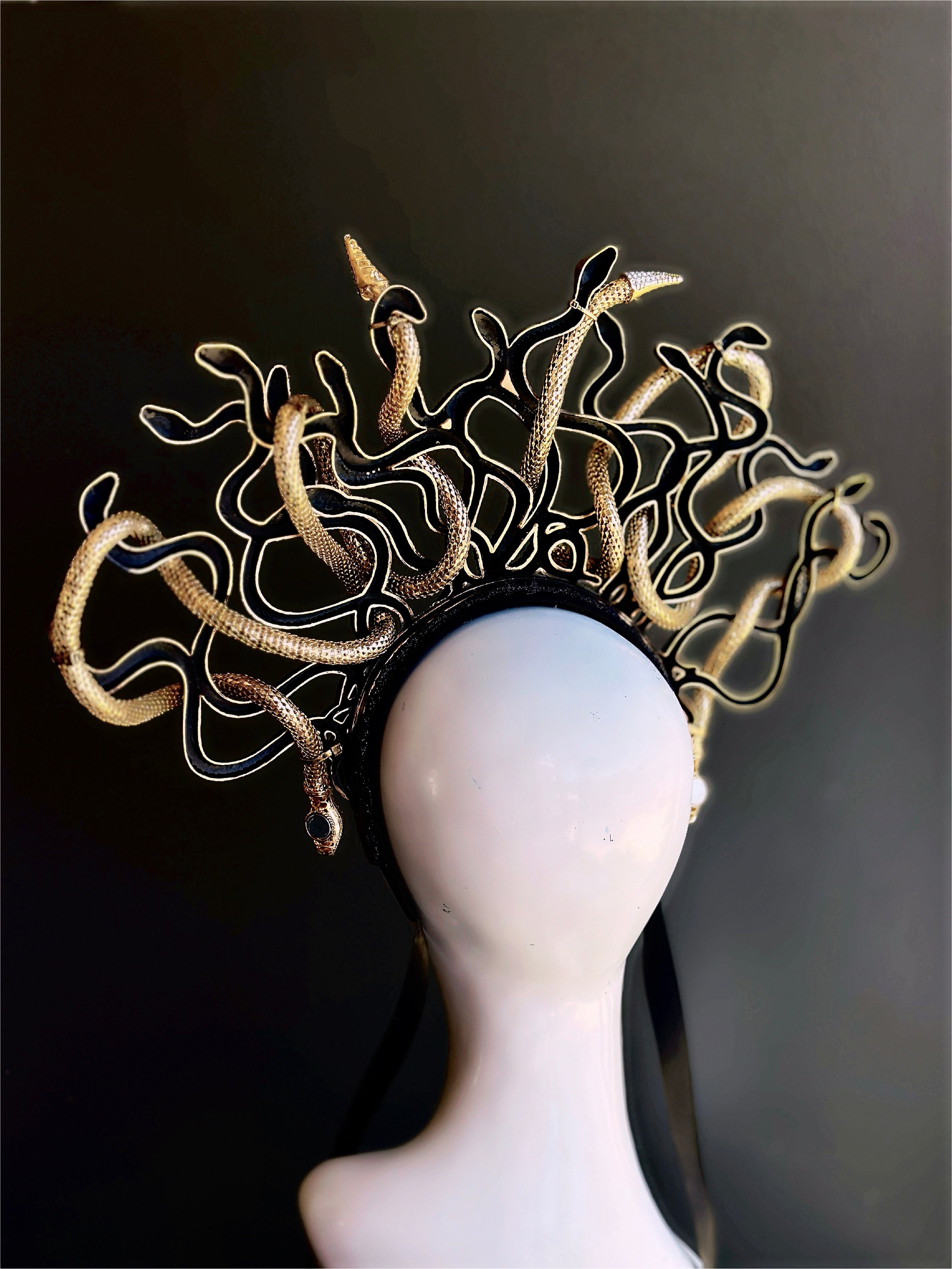 backside of a fantasy cosplay gold Medusa serpent crown accessory with ornate mythological details