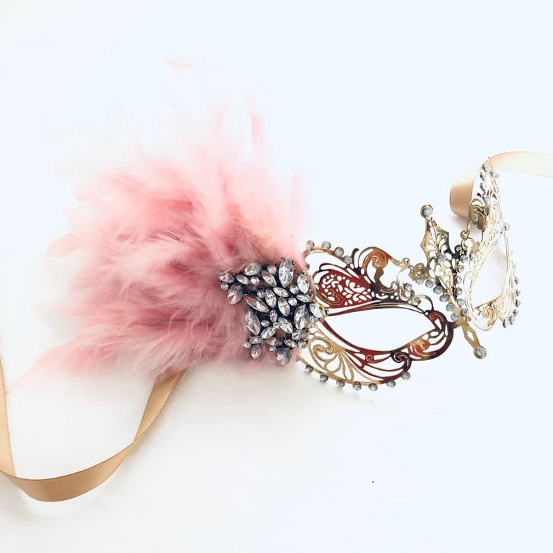 Gold and black men’s mask with matching girl’s gold filigree pink feather masquerade mask.