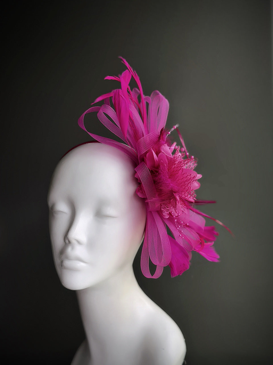 hot pink fascinator hat with curled tulle and feathers