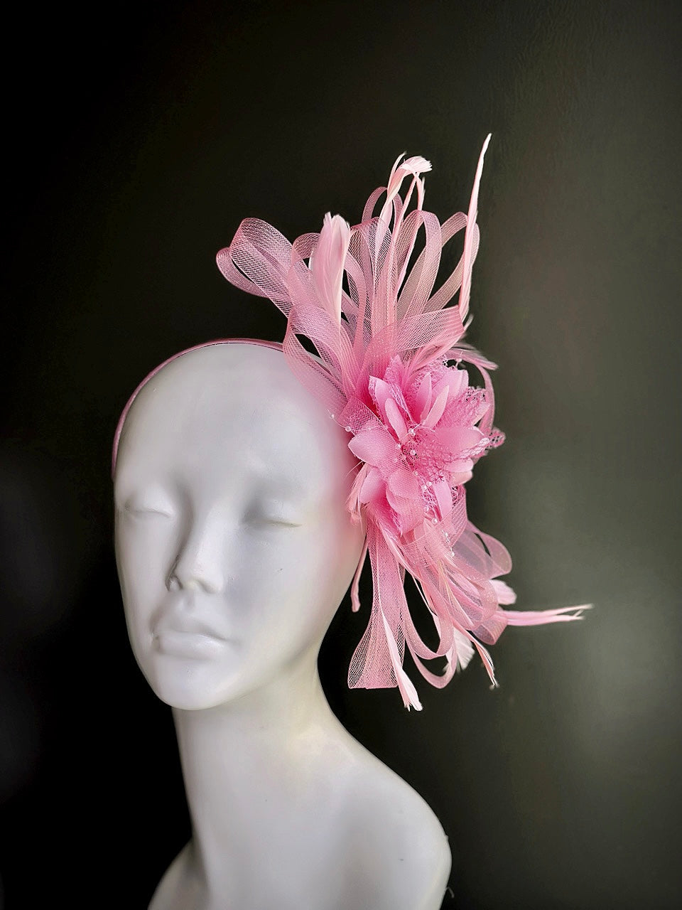 light pink fascinator hat with feathers and mesh ribbon loops