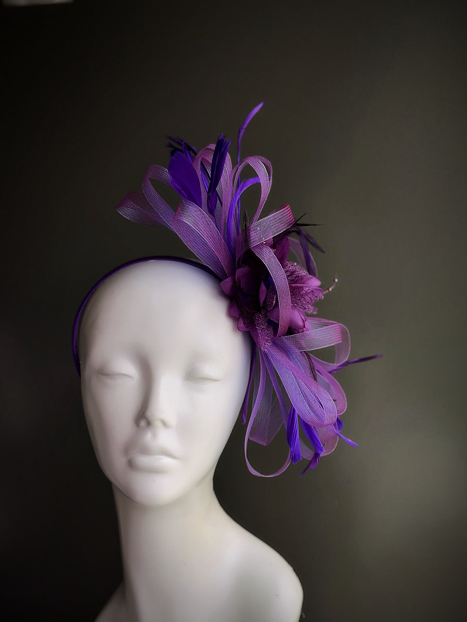 purple fascinator hat with curled tulle ribbons and feathers