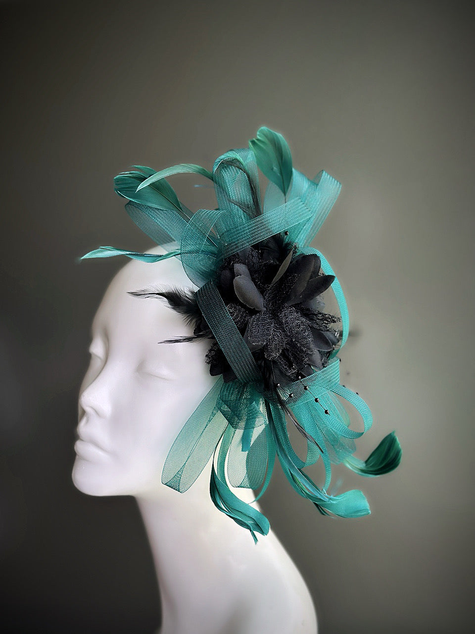 teal and black fascinator hat with tulle loops and feathers