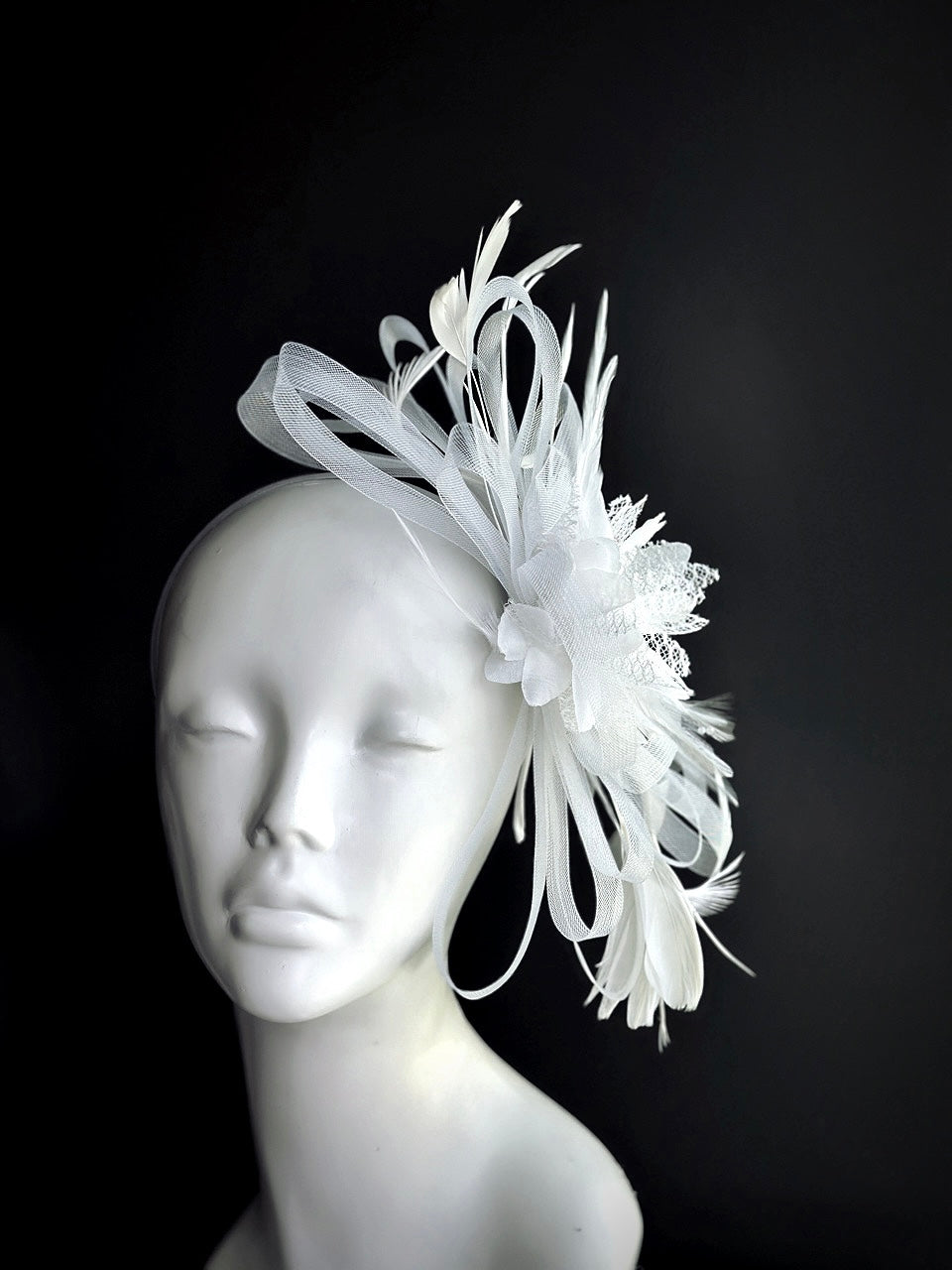 white fascinator hat with soft feather and tulle bow design