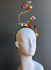 Artistic floral branch fascinator headband with flowers and birds.