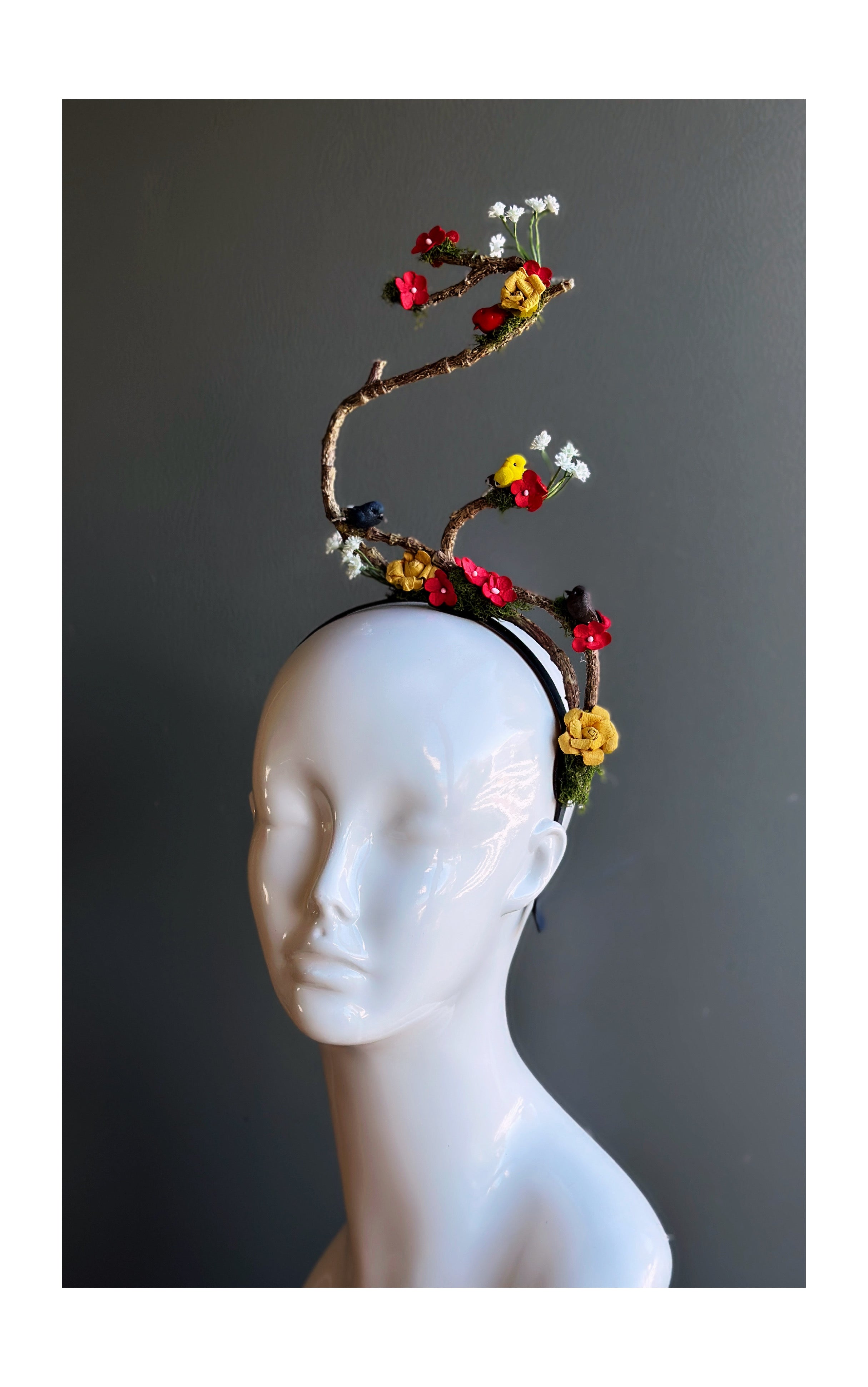 Artistic floral branch fascinator headband with flowers and birds.