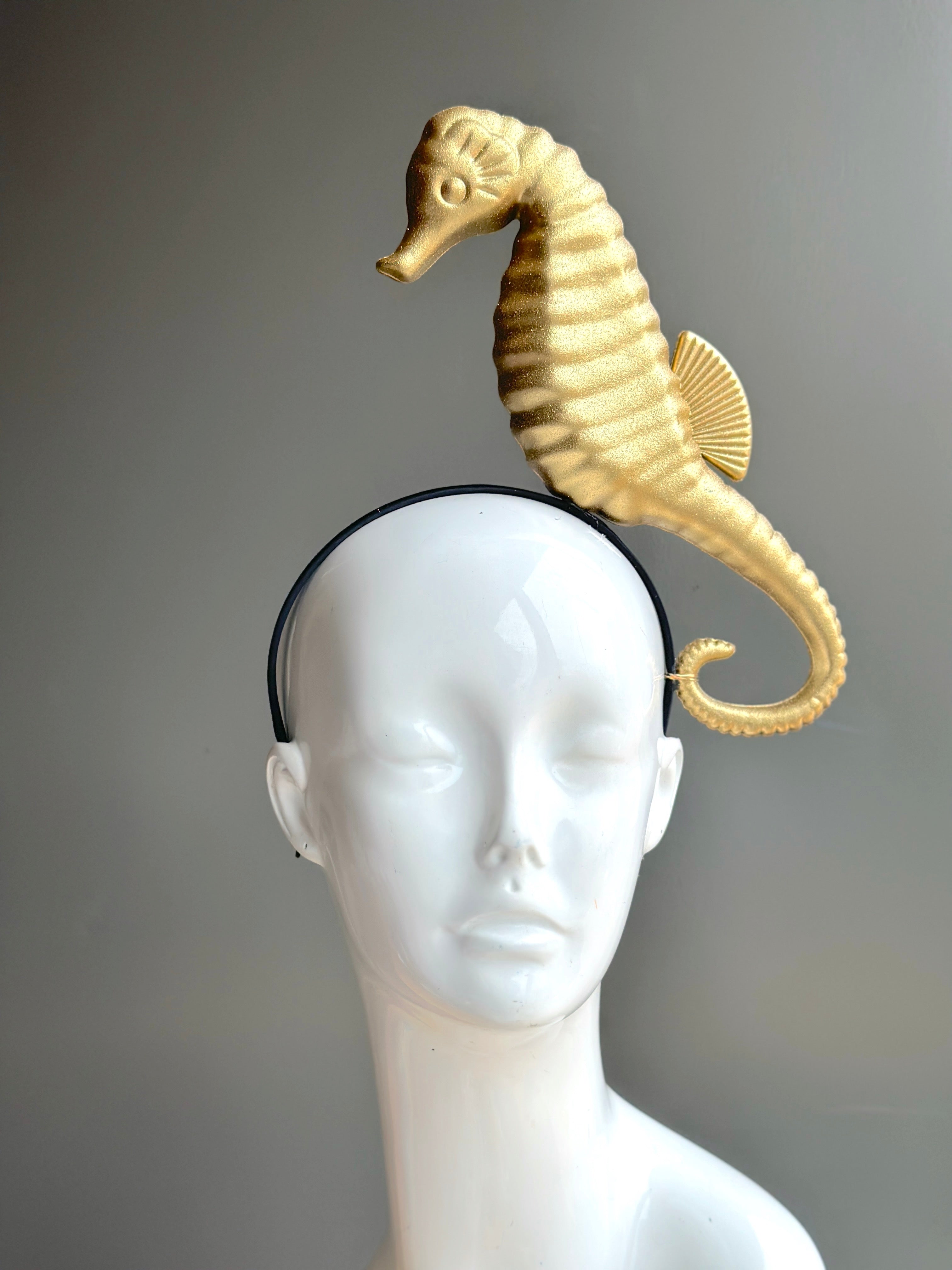 Gold seahorse fascinator on a sleek headband, ideal for ocean-themed events, beach weddings, and standout fashion.
