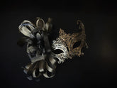 Elegant gold and black masquerade mask with feathers and filigree lace metal, perfect for balls, proms, and Venetian carnival events.