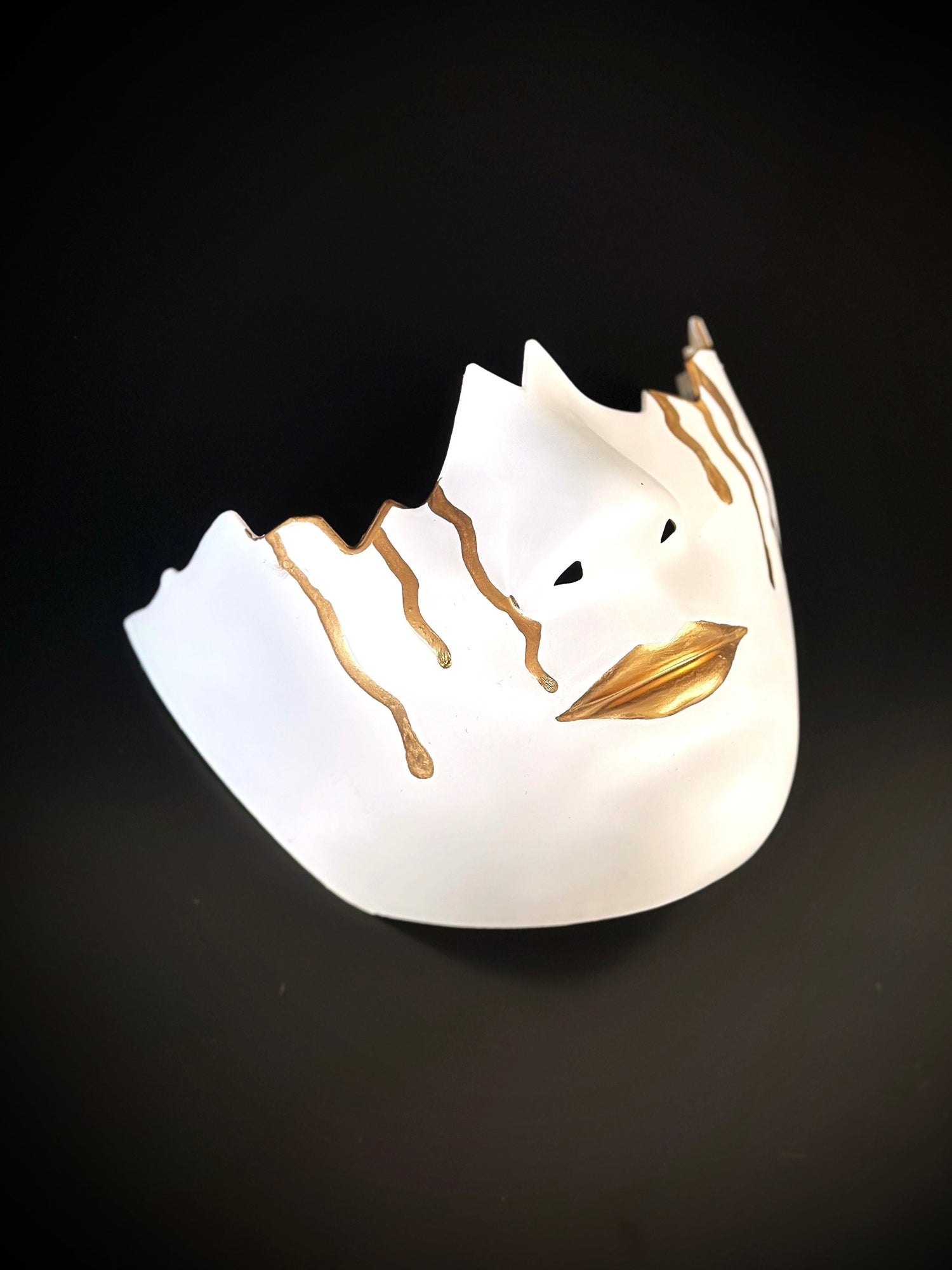 White mouthguard masquerade mask with gold teardrops and lips, oversized lower-face design