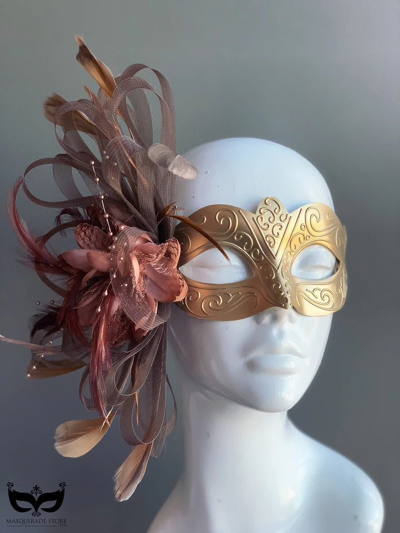 Gold mask with brown feathers and floral accents, designed for masquerade balls, proms, and Venetian carnivals.