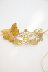 Elegant gold lace masquerade mask with glitter butterfly accent, perfect for prom, masquerade balls, and costume parties.