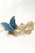 Elegant gold lace masquerade mask with glitter blue butterfly accent, ideal for proms, parties, and masquerade balls.