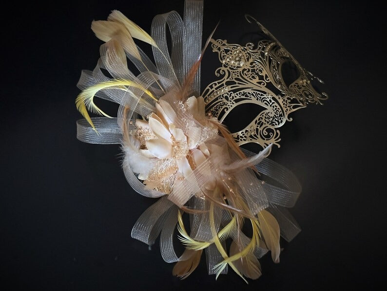Elegant gold lace masquerade mask with feathers, rhinestones, and floral accents for women, ideal for balls and proms.