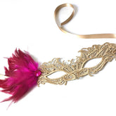 Elegant gold lace mask with pink feathers and jewel accent, perfect for weddings, proms, and masquerade balls.