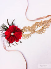 Elegant gold lace masquerade mask with red feathers and rhinestone accent for women’s prom, Mardi Gras, and costume events.