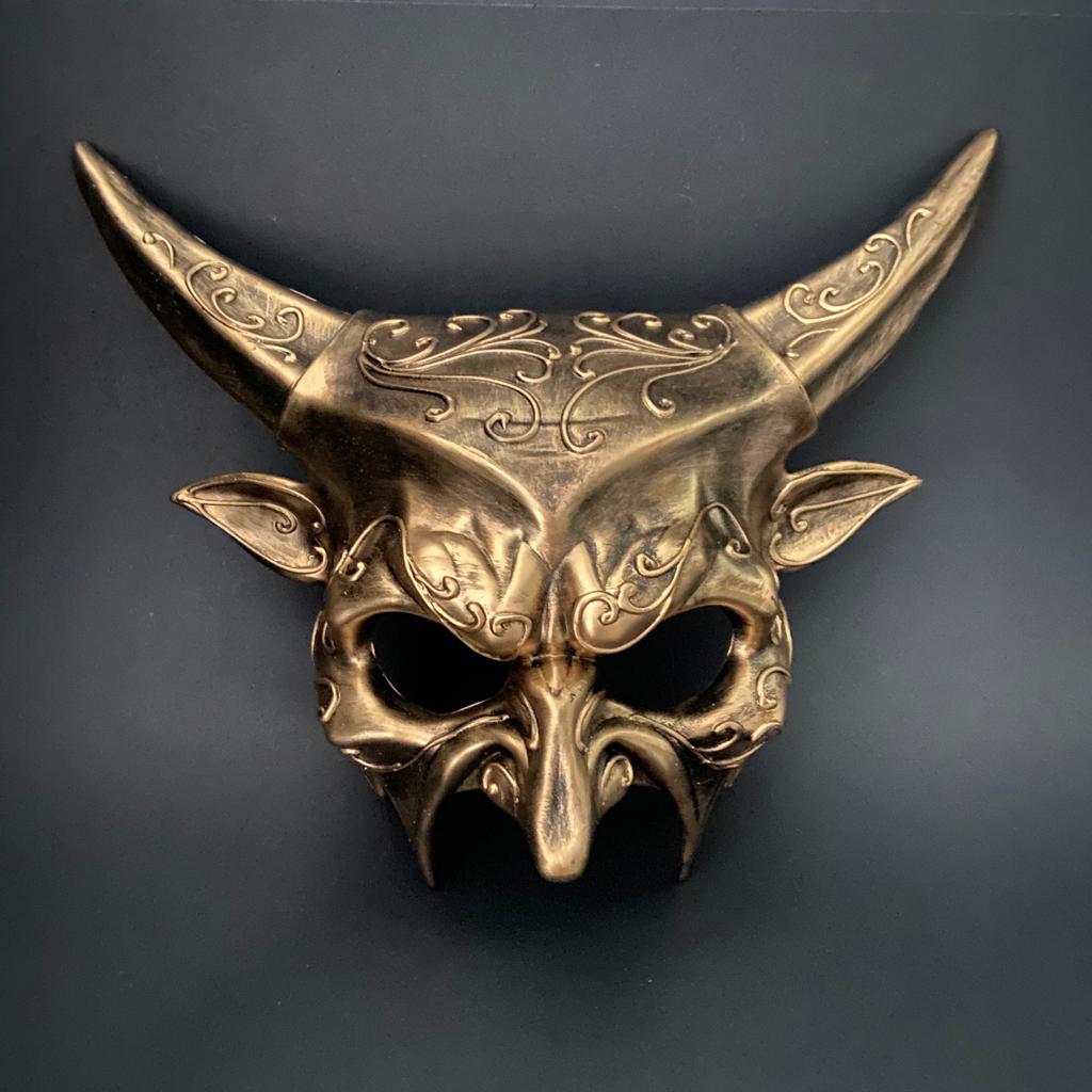 Men’s gold masquerade mask with intricate engravings and horned design