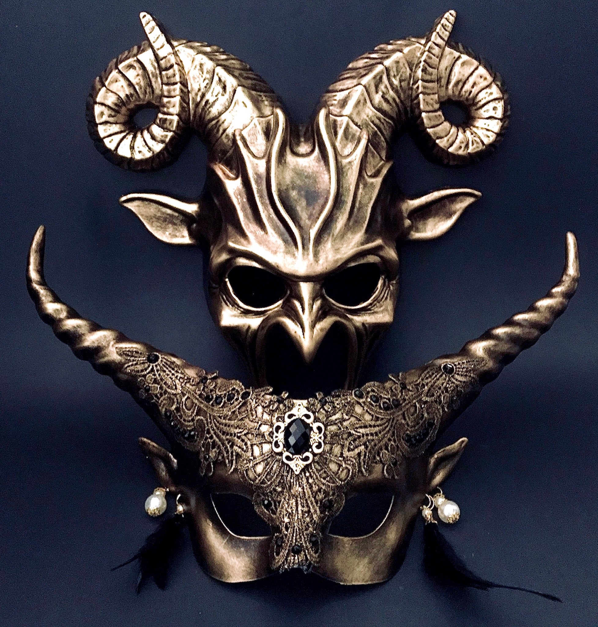 Gold gothic couples masquerade masks with horns and lace details.