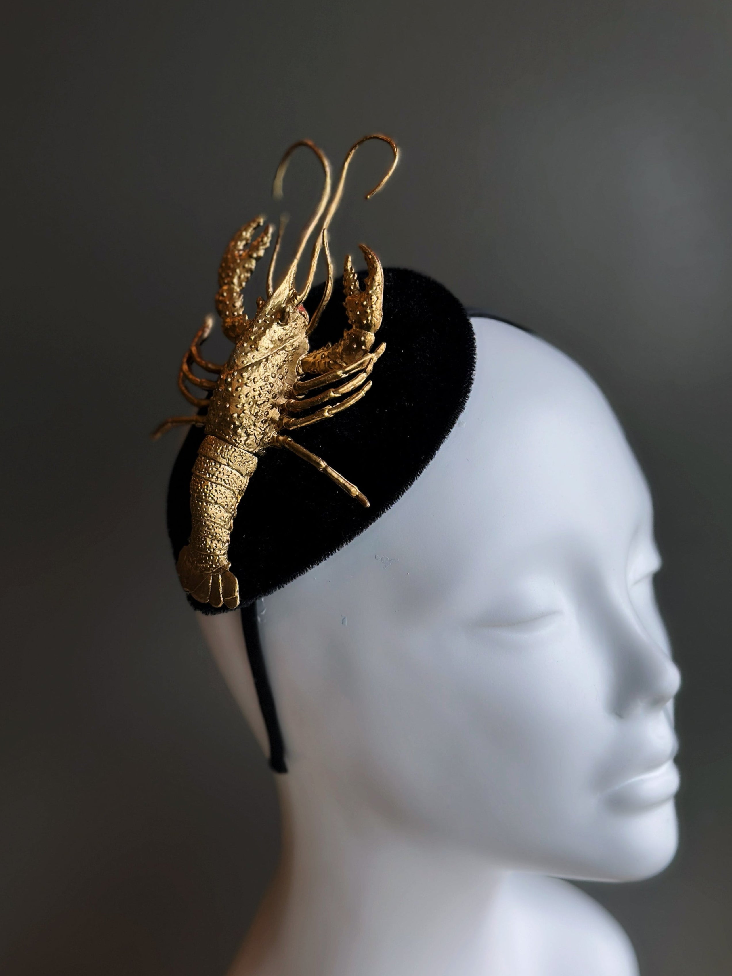 Black velvet fascinator adorned with a gold-tone crawfish, perfect for Mardi Gras and Southern-inspired events.