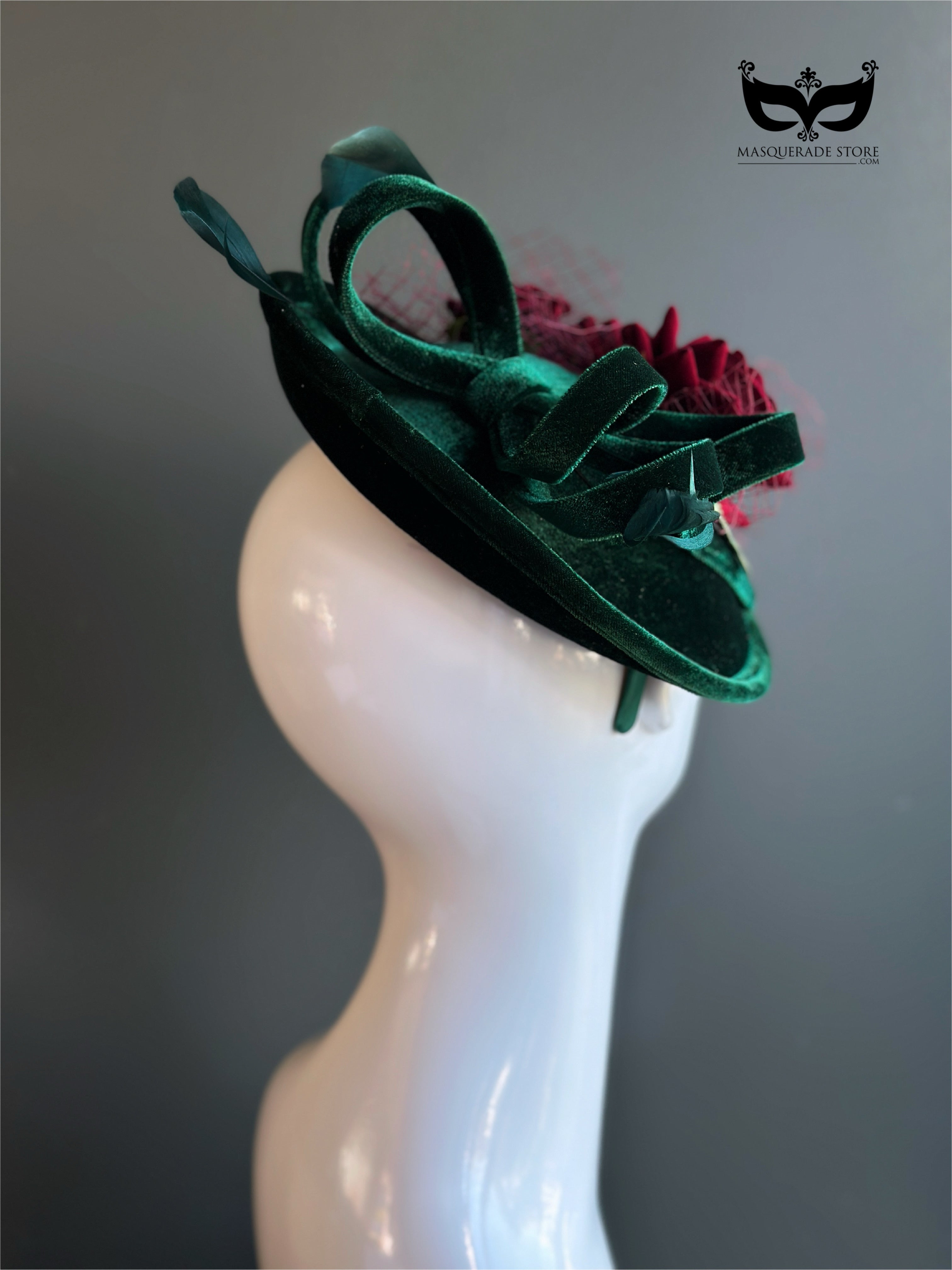 Elegant red rose headpiece on green velvet base.