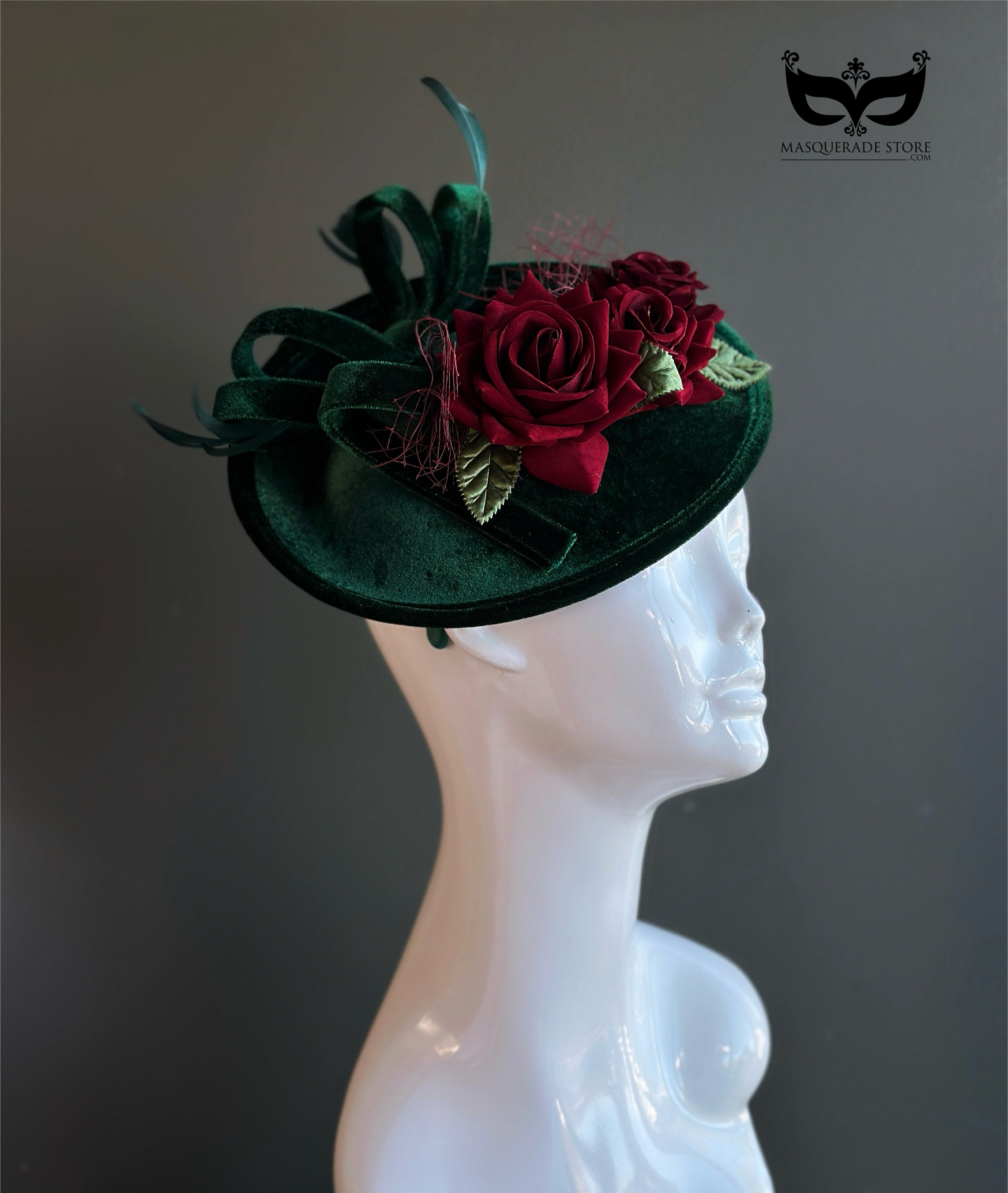 Elegant red rose headpiece on green velvet base.
