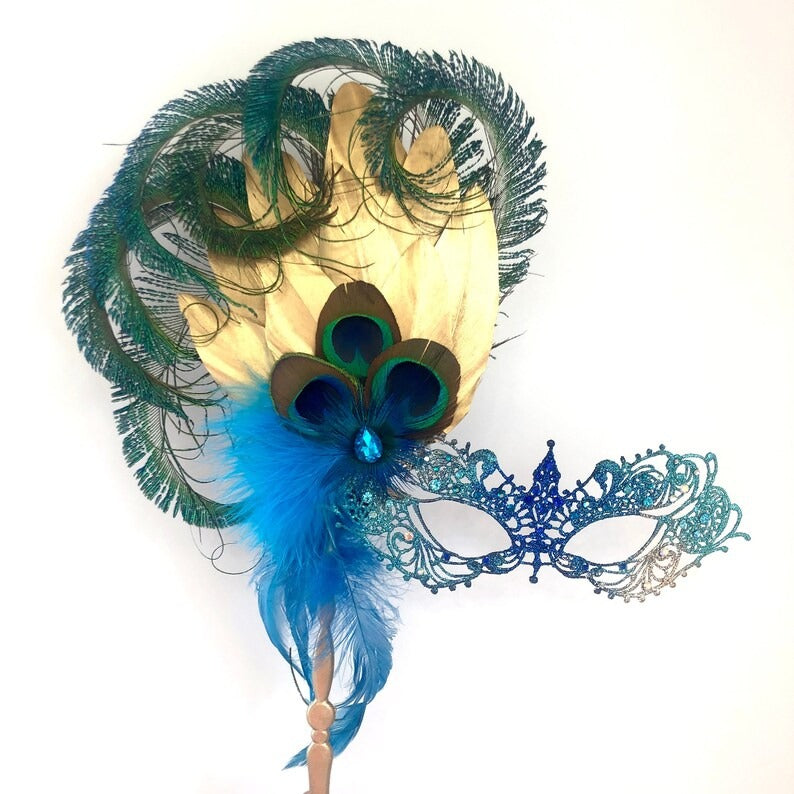 Venetian handheld masquerade mask with peacock feathers, jeweled details, and blue feather plumes.