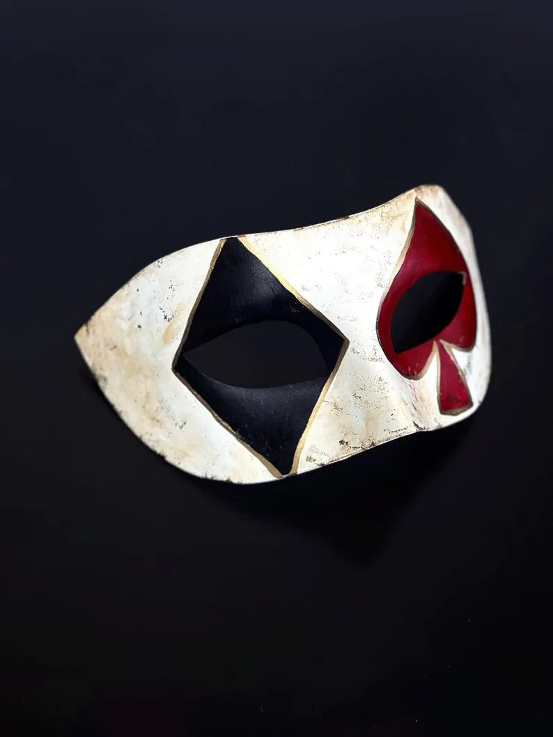 Venetian Harlequin masquerade mask with distressed ivory finish, black diamond, and red spade design, perfect for Carnival and Halloween.