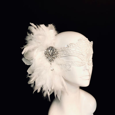 Women's white lace masquerade mask with white feathers and a crystal brooch