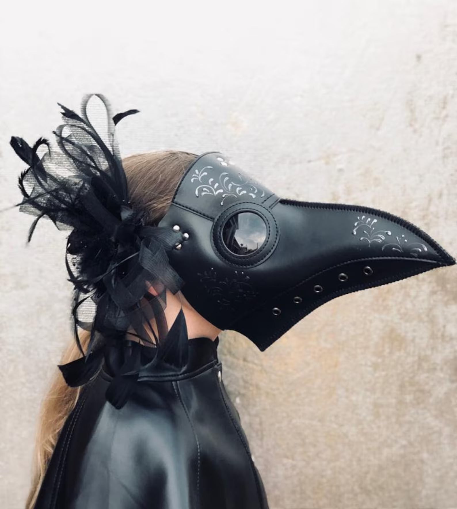 Kids black plague mask with filigree detailing and black feathers, perfect for Halloween or masquerade parties.