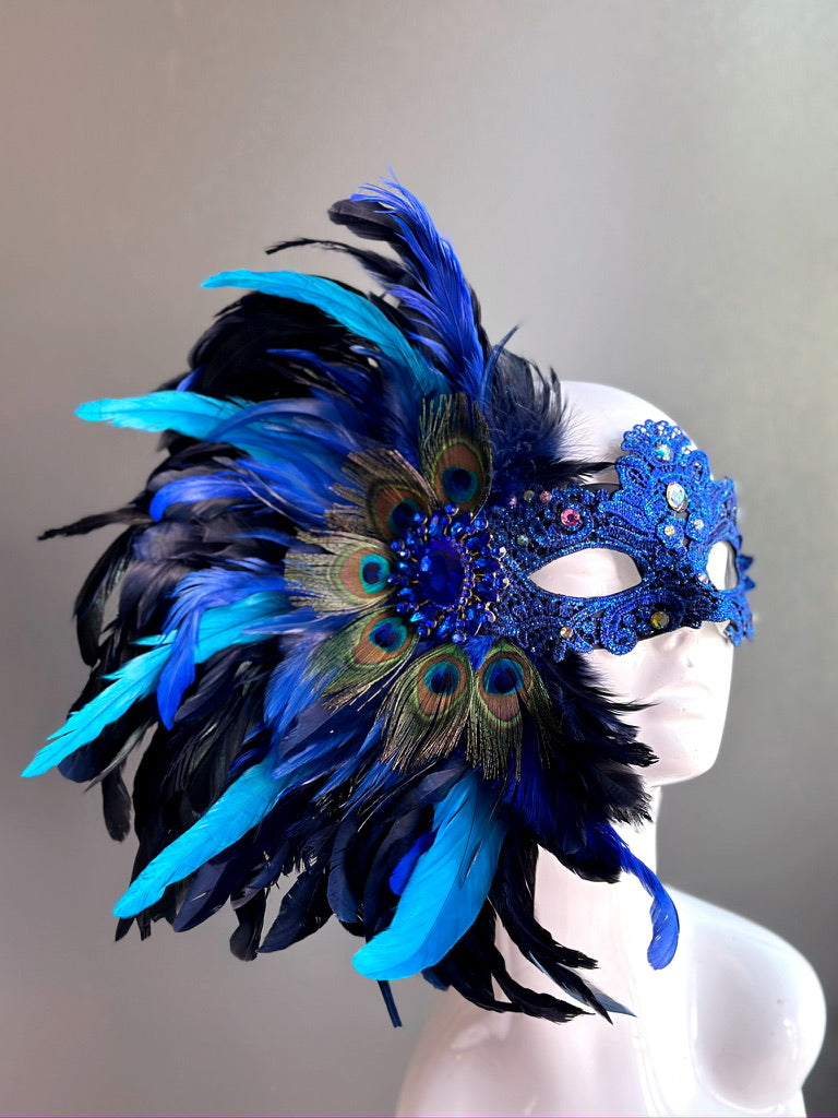 Lux Feather Mask in black and blue with peacock feather accents and intricate detailing.